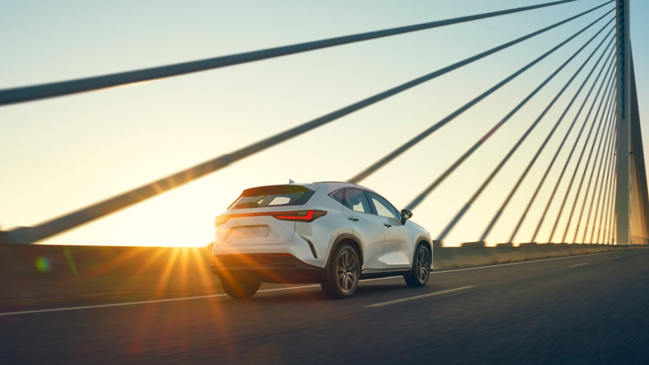 Lexus NX driving across a suspension bridge