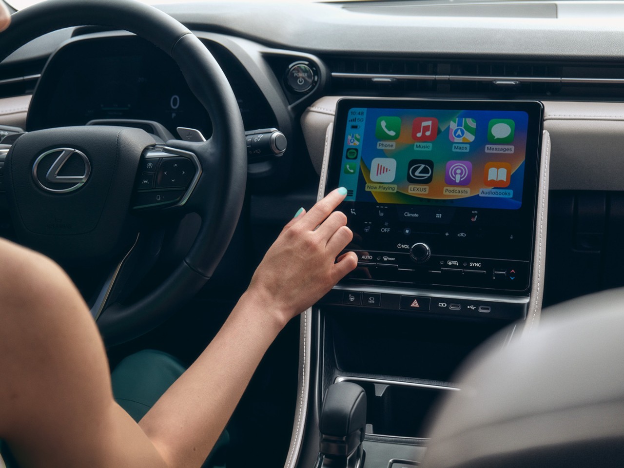 A person interacting with a Lexus multimedia system